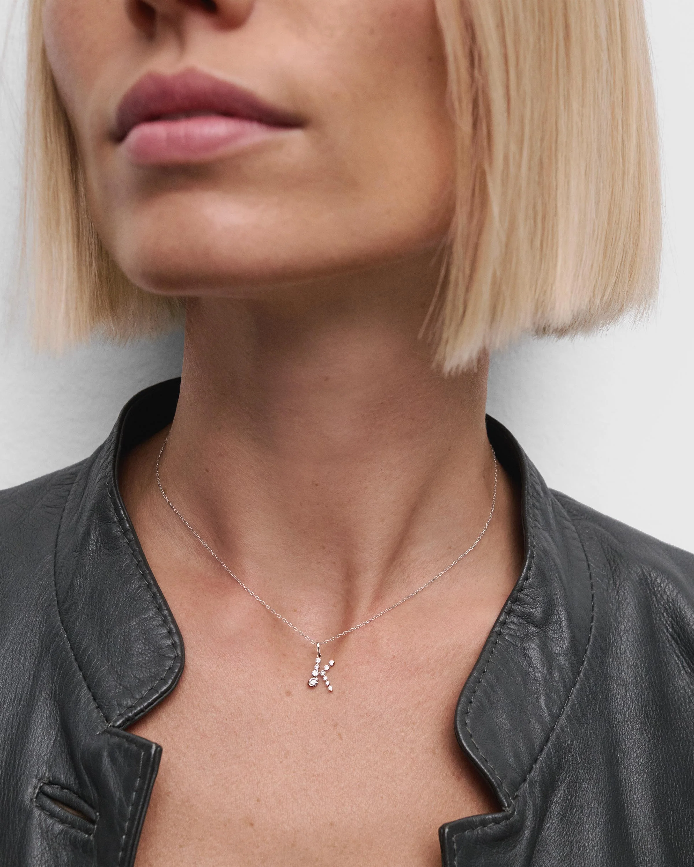 Diamonds and white gold K initial pendant
